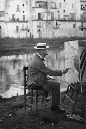 Santiago Rusi&ntilde;ol pintant les cases de l'Onyar